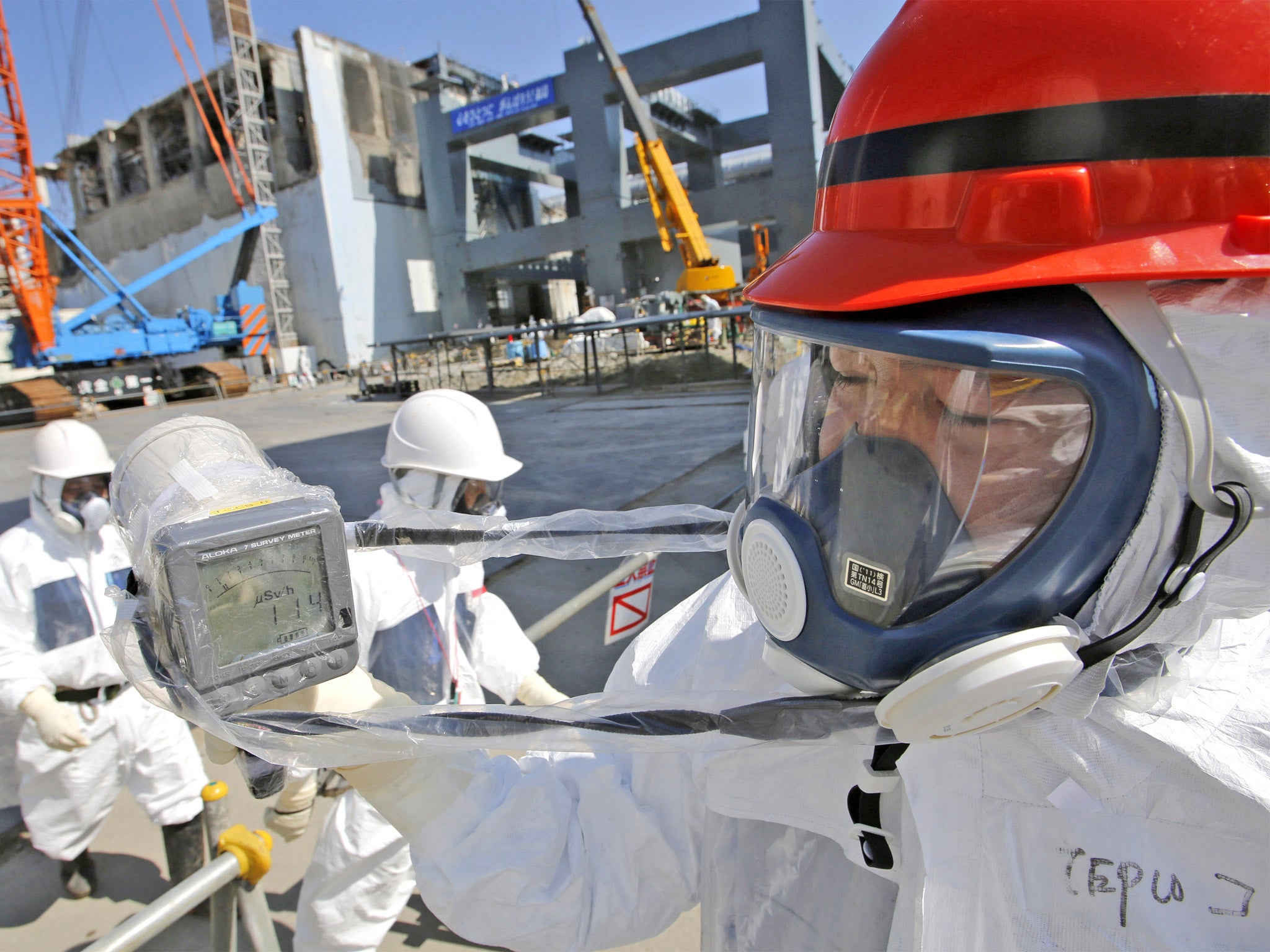 A radiation monitor indicates 114 microsieverts per hour near the building housing Fukushima’s reactor unit four