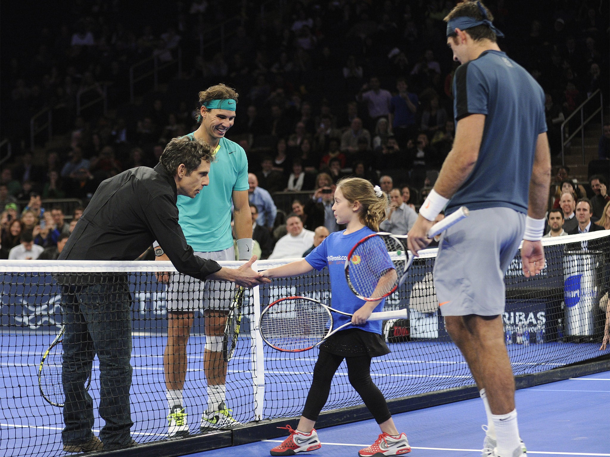 Actor Ben Stiller shakes hands with nine-year-old Rebecca Suarez as their doubles partners, Rafael Nadal and Juan Martin del Potro, look on