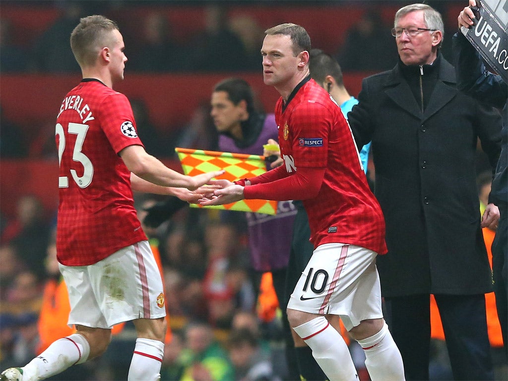 Sir Alex Ferguson looks on as Wayne Rooney comes on as a sub