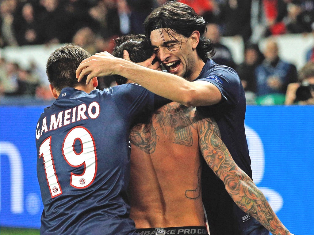 Unshirted Ezequiel Lavezzi is congratulated by his teammates