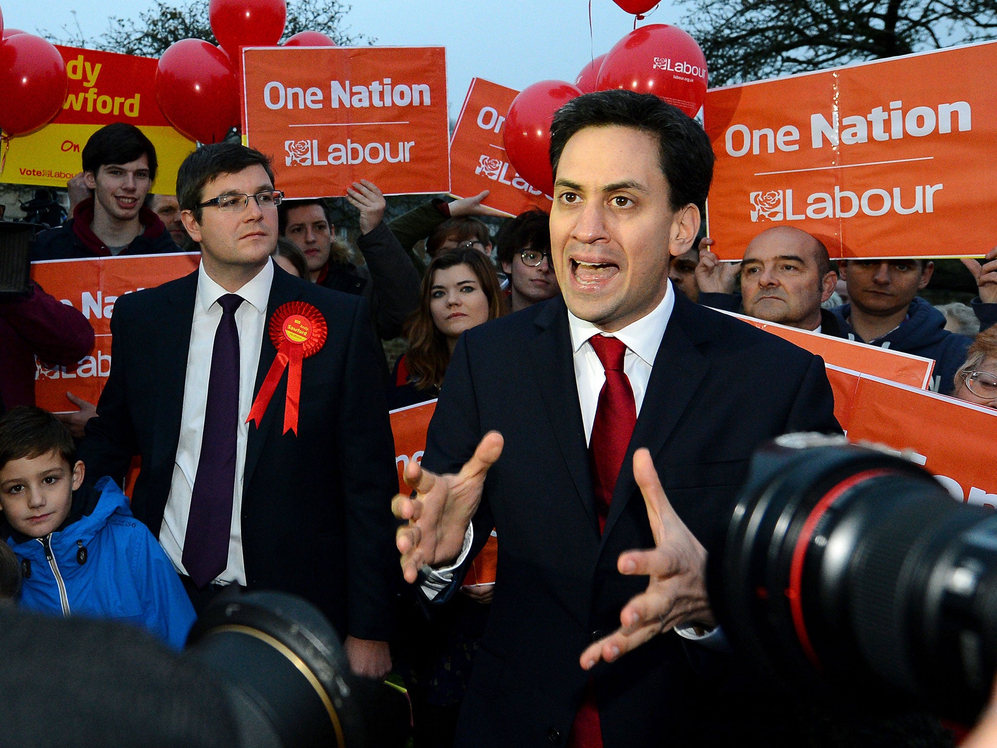 Candidate for Britain's opposition Labour party Andy Sawford (L) looks on as party leader Ed Miliband speaks to reporters after Sawford won the Corby Byelection in Corby, England on November 16, 2012.