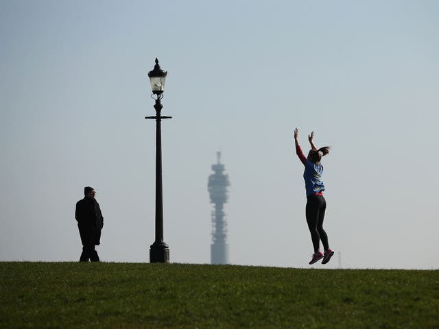 A woman exercises in the sunshine on Primrose Hill on March 4, 2013 in London, England.