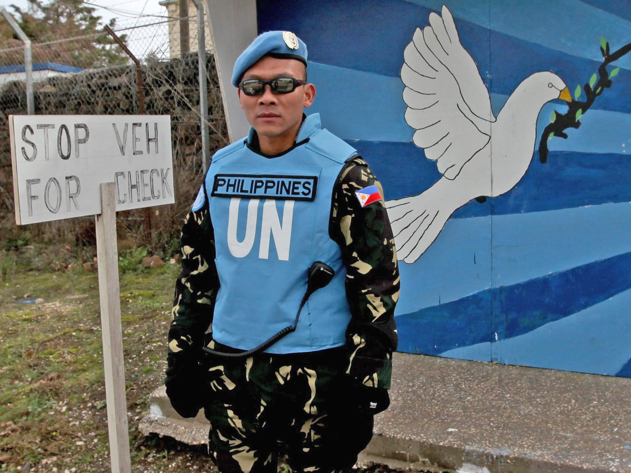 A UN Filipino solider guards the entrance to the UN headquarters near the Israeli-Syrian border