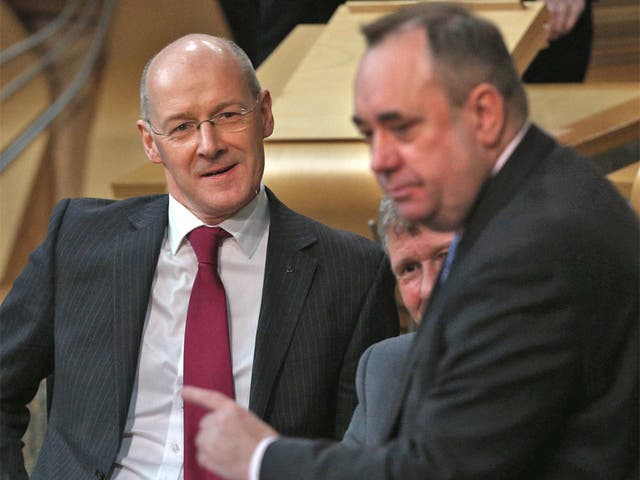 Finance minister John Swinney watches Scottish First Minister Alex Salmond during First Minister's Questions at the Scottish Parliament in Edinburgh