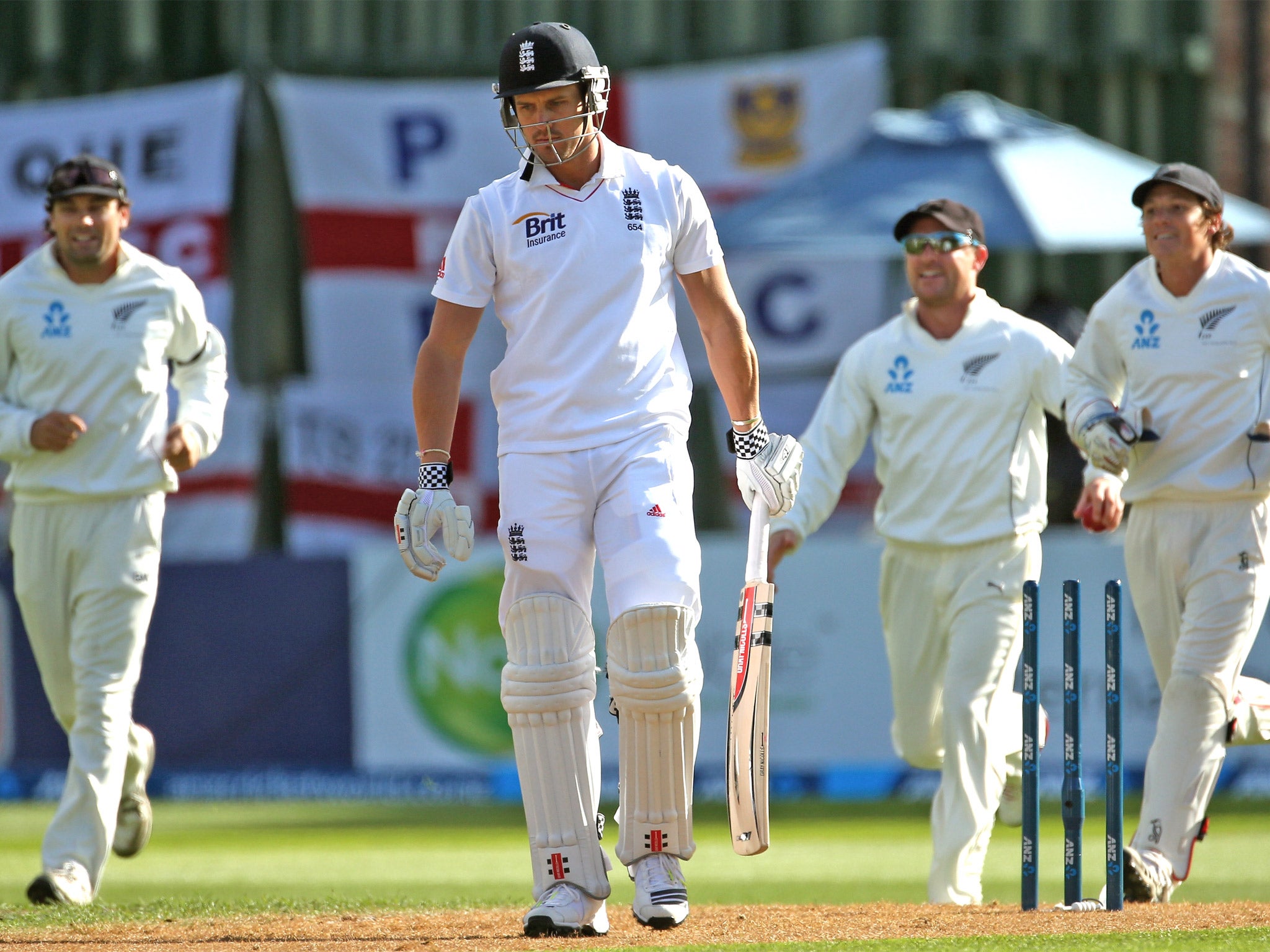 Nick Compton, of England, walks off the field after being bowled by Tim Southee, of New Zealand