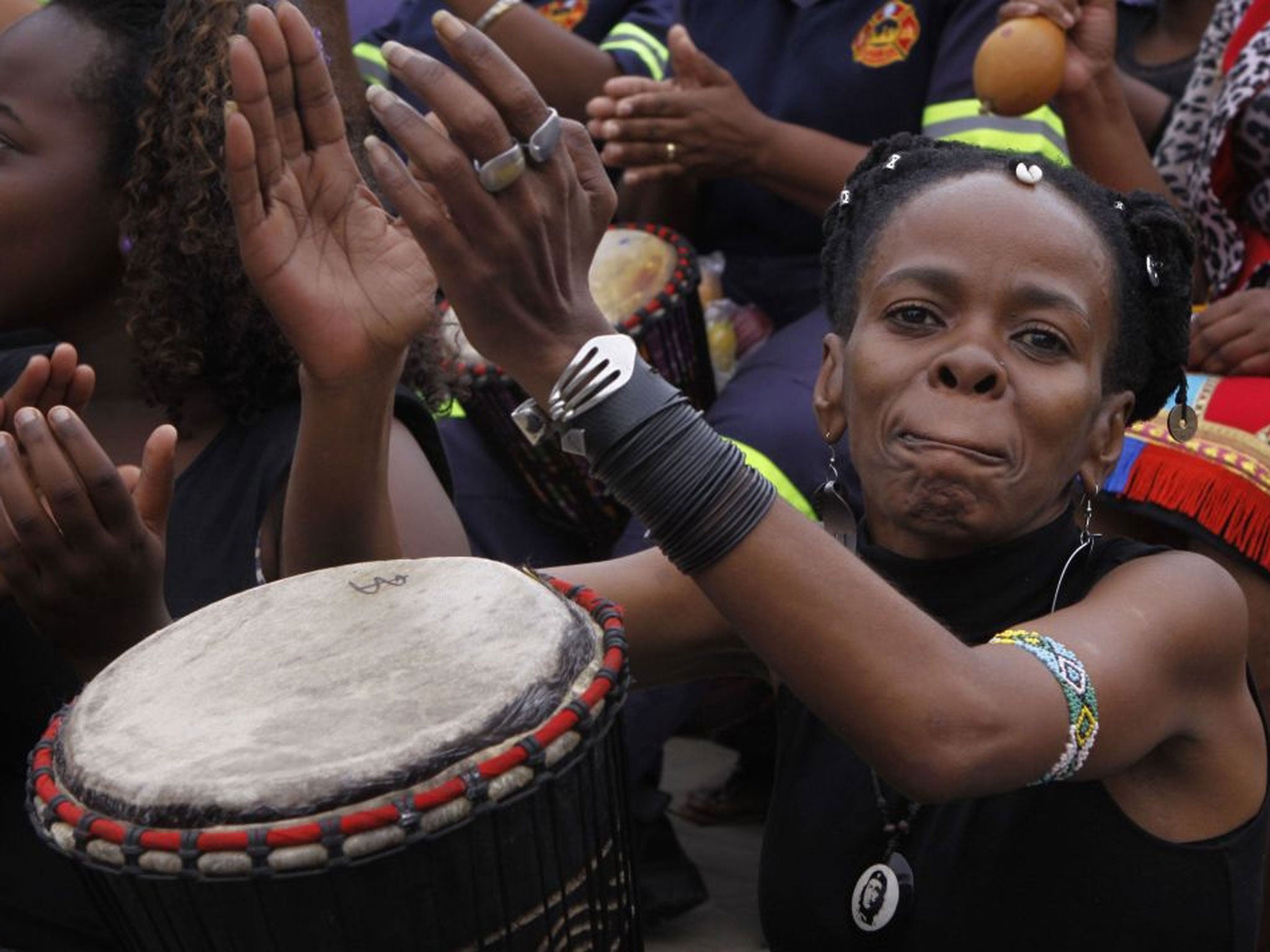 Women take part in a drumming session in Johannesburg as part of a protest against violence against women and children, 8th March 2013.