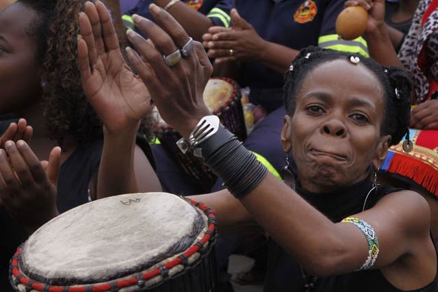 Women take part in a drumming session in Johannesburg as part of a protest against violence against women and children, 8th March 2013.