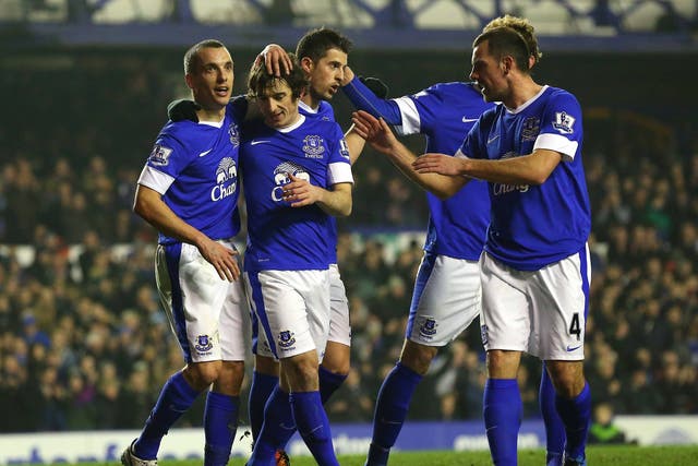 Leighton Baines is congratulated by his team-mates