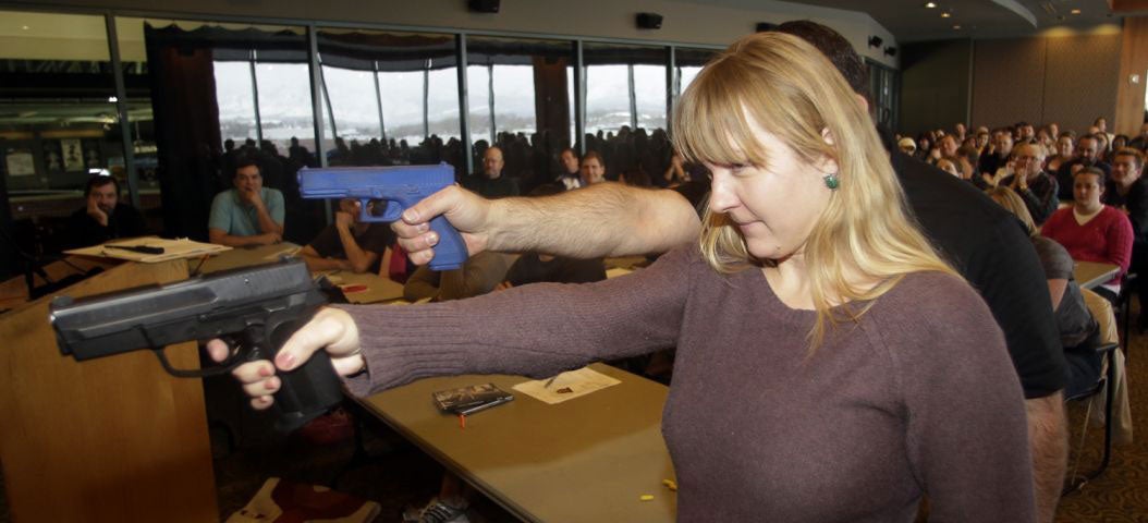 Joanna Baginska, a fourth-grade teacher from Odyssey Charted School, in American Fork, Utah, aims a 40 cal. Sig Sauer during concealed-weapons training for the teachers in West Valley City, Utah