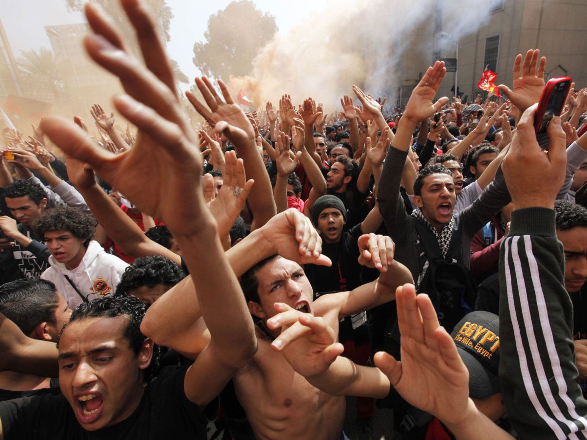 Fans of Al-Ahly football club celebrate in Cairo after an Egyptian court confirmed death sentences against 21 people for their role in a deadly 2012 riot