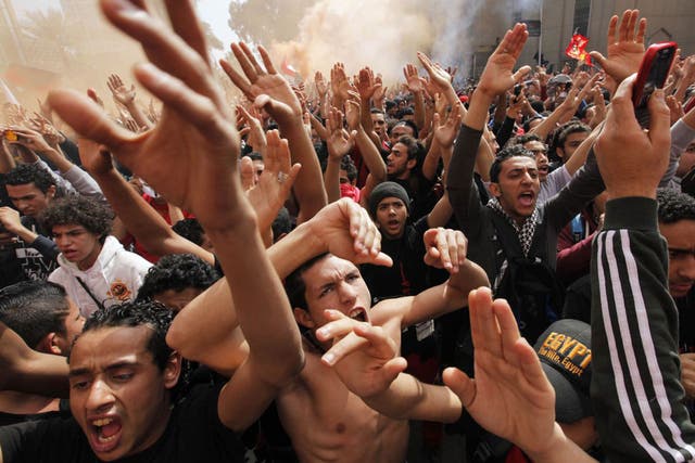 Fans of Al-Ahly football club celebrate in Cairo after an Egyptian court confirmed death sentences against 21 people for their role in a deadly 2012 riot 