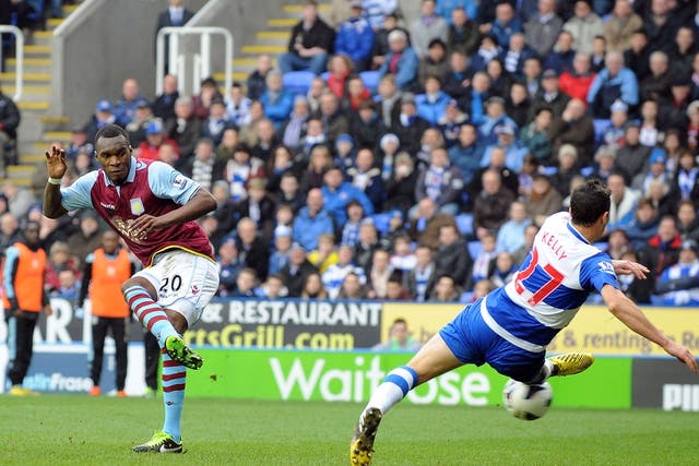 Christian Benteke of Aston Villa shoots past Stephen Kelly of Reading to score their first goal