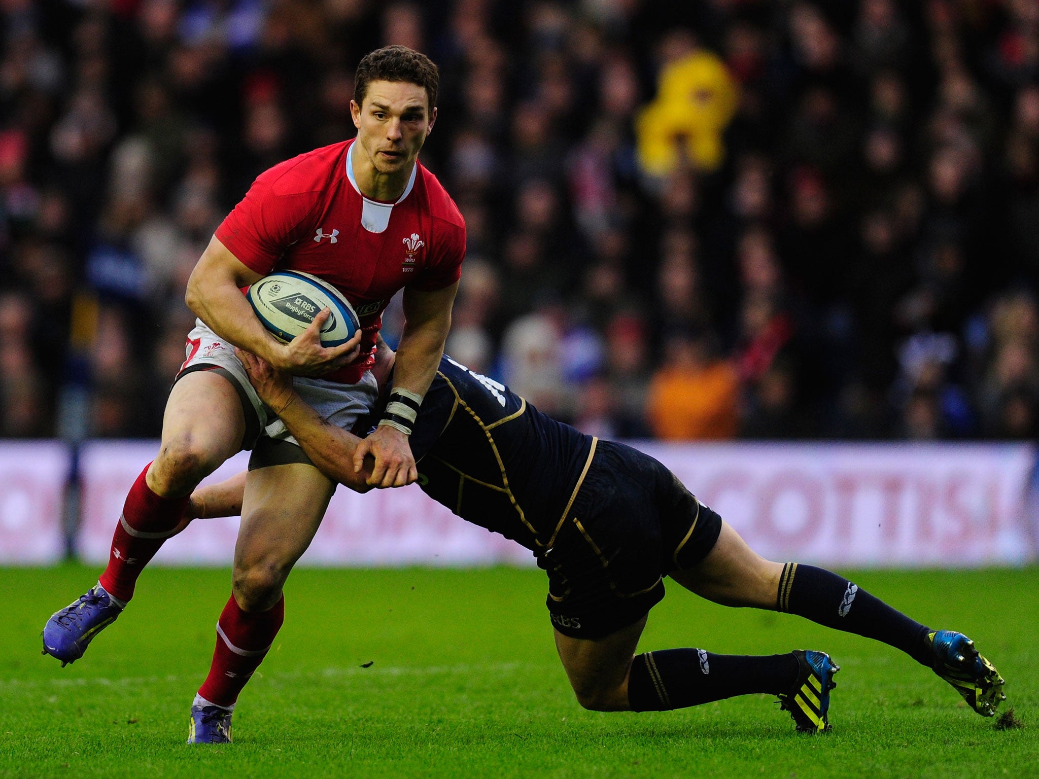 George North of Wales is tackled