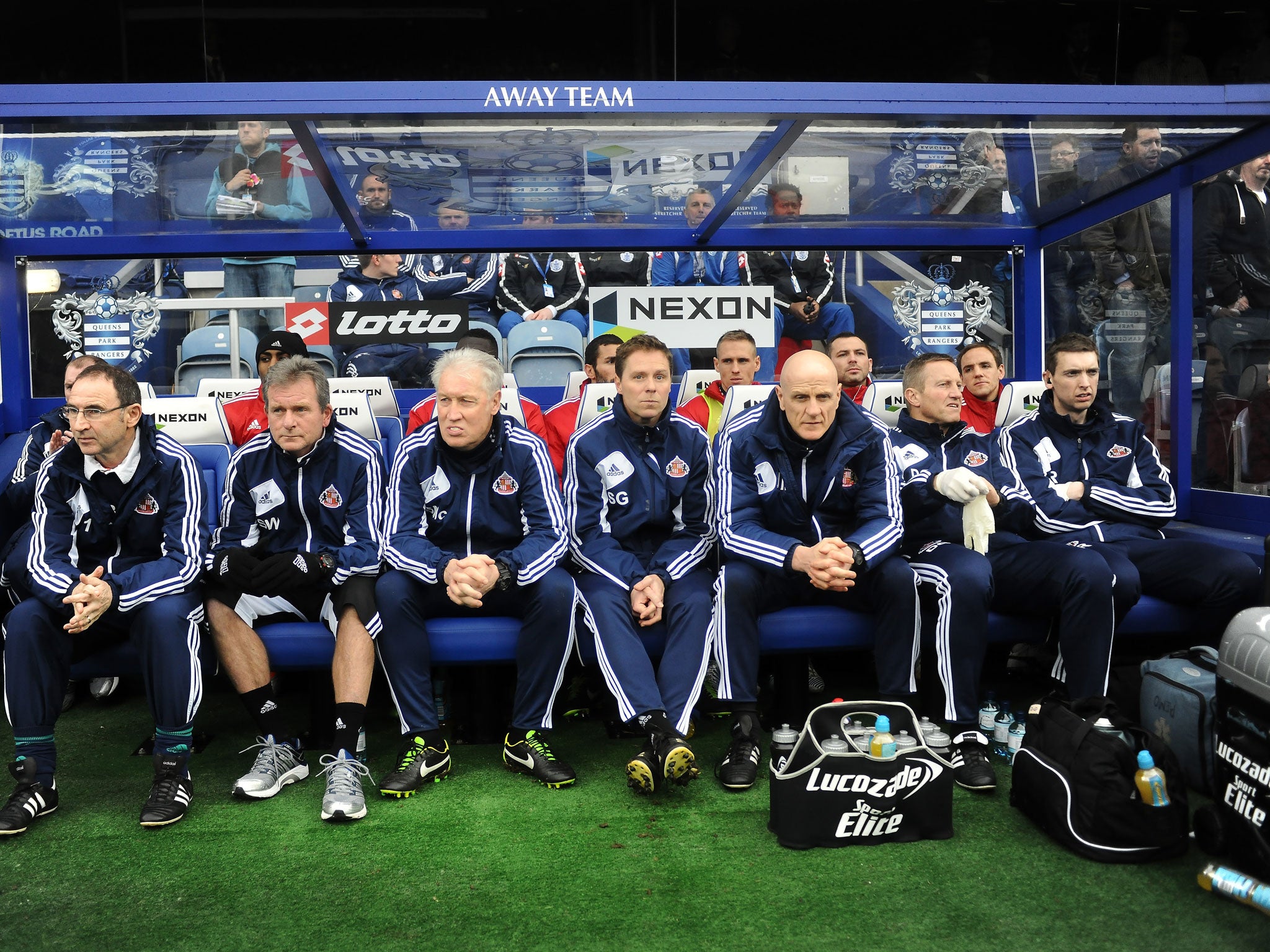 Martin O'Neill manager of Sunderland (L) and his coaching team look on from the dug out