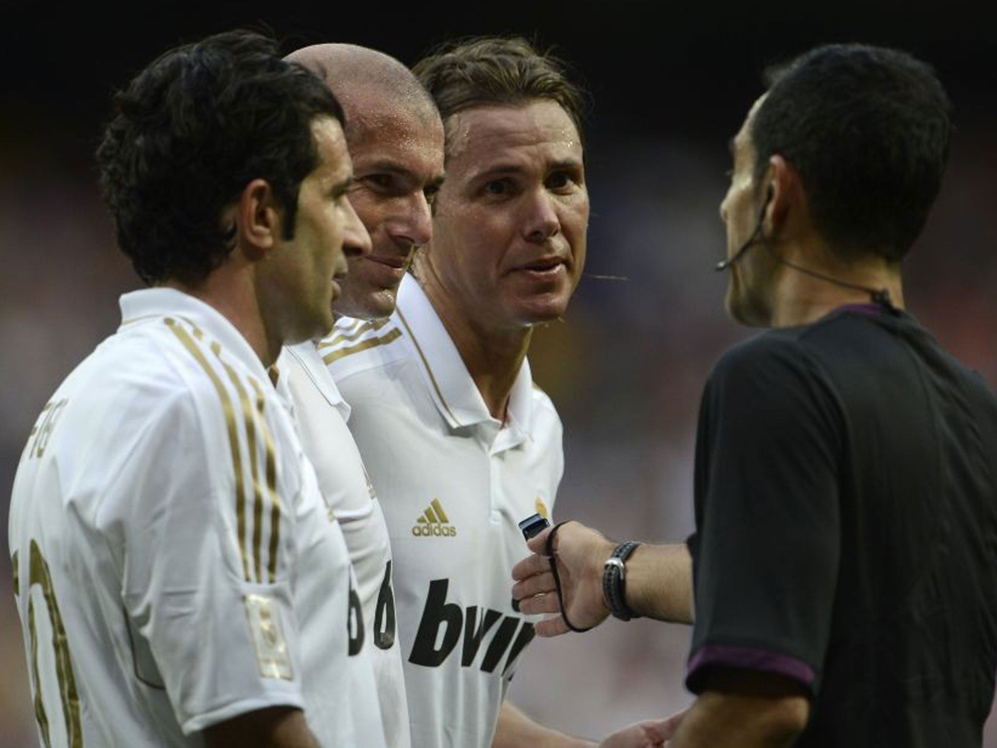 White heat: Luis Figo, Zinedine Zidane and Fernando Redondo plead with the referee in last year’s legends game between Madrid and United