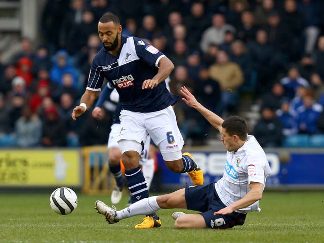 Jason Lowe of Blackburn Rovers slides in for a tackle on Liam Trotter of Millwall