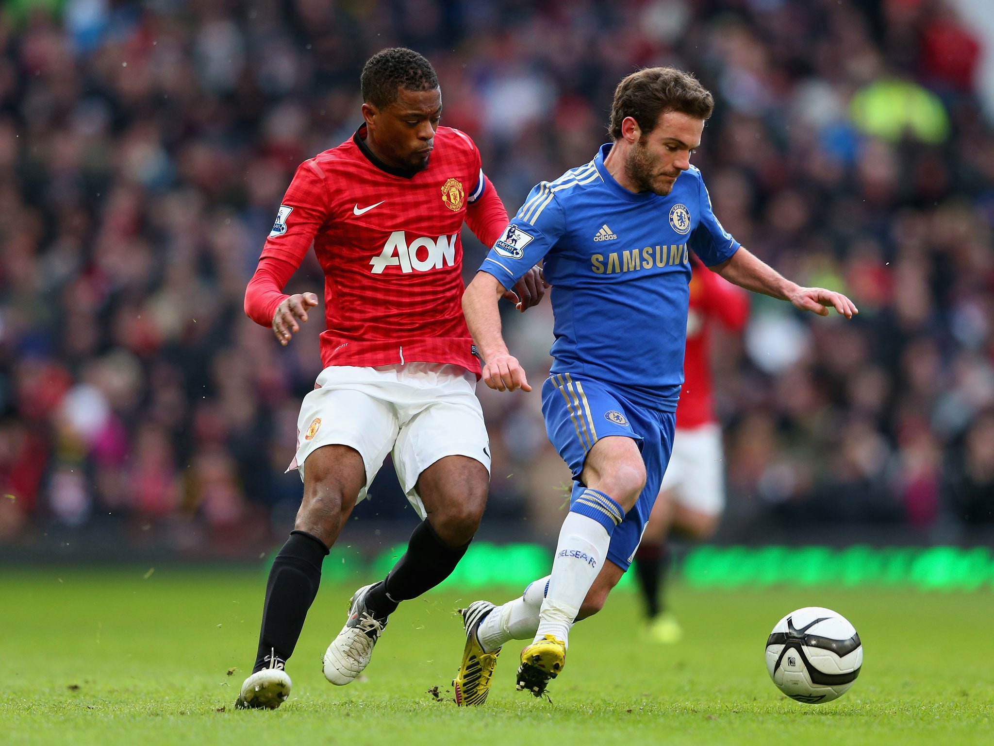 Juan Mata of Chelsea competes with Patrice Evra