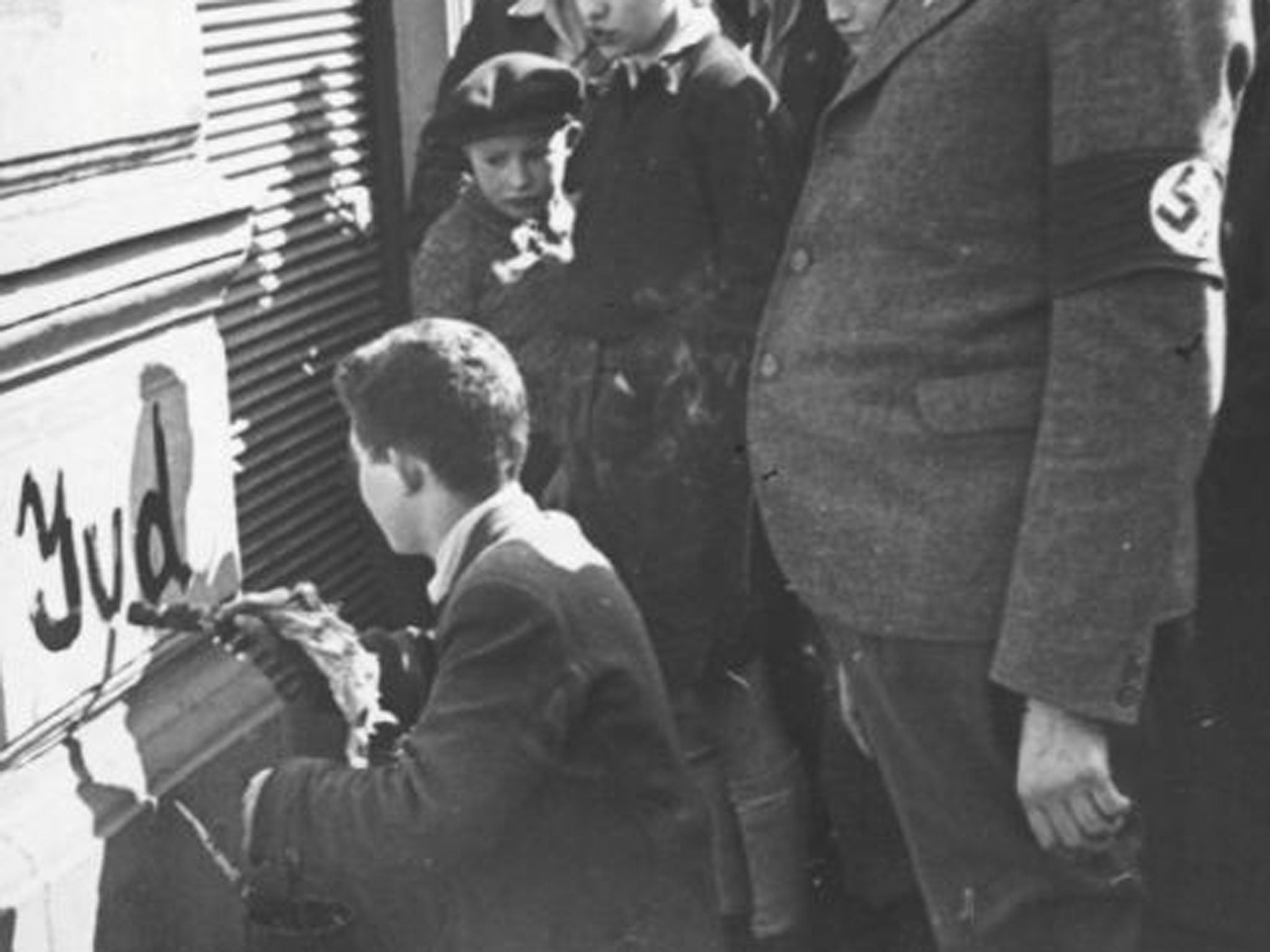 A boy writes ‘Jud’ (Jew) on a building in Vienna in 1938