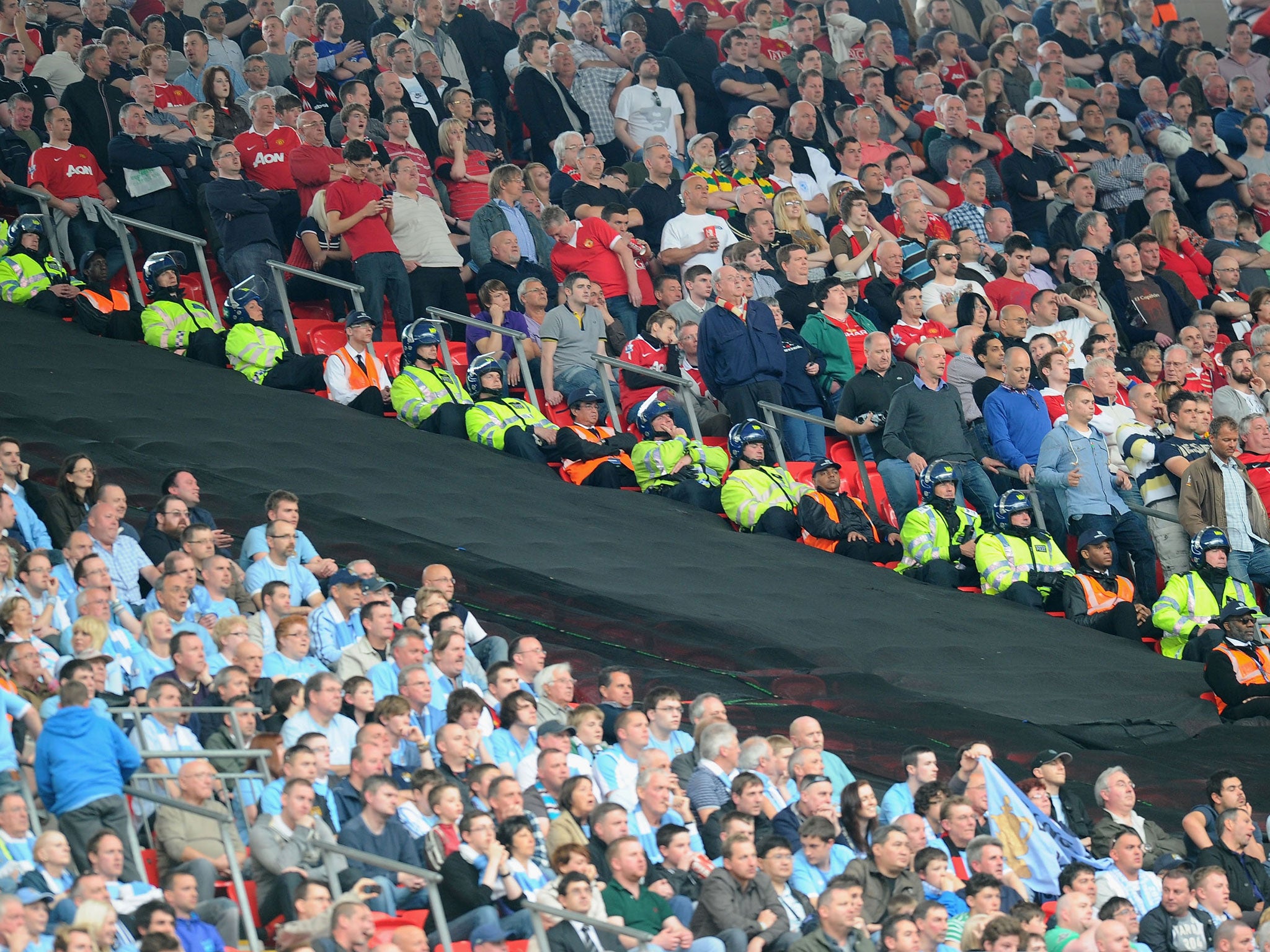 The segregated fans watch the game during the FA Cup sponsored by E.ON semi final match between Manchester City and Manchester United at Wembley Stadium on April 16, 2011
