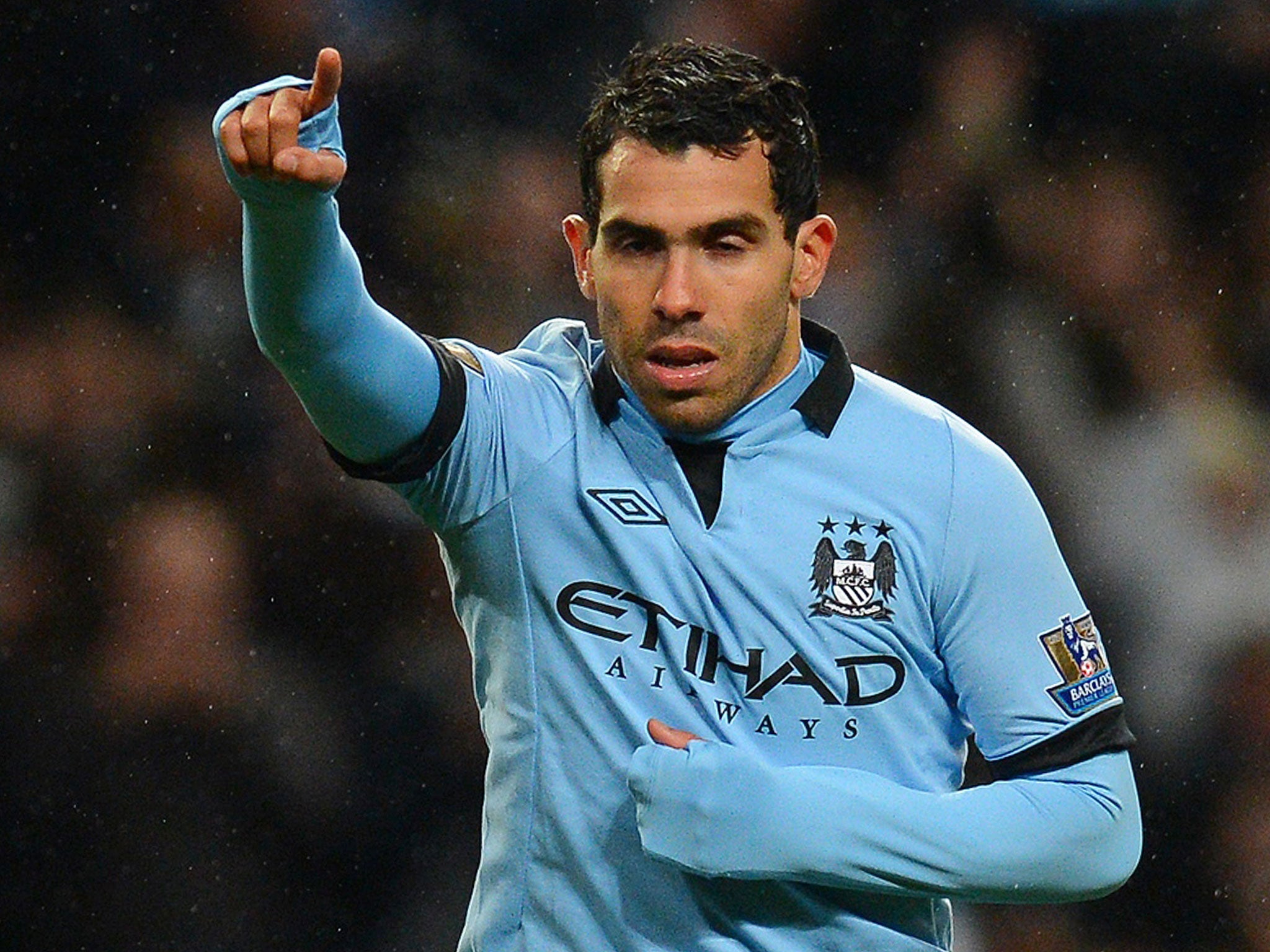 Manchester City's Argentinian forward Carlos Tevez celebrates after scoring his team's fourth goal and his third to complete his hat-trick