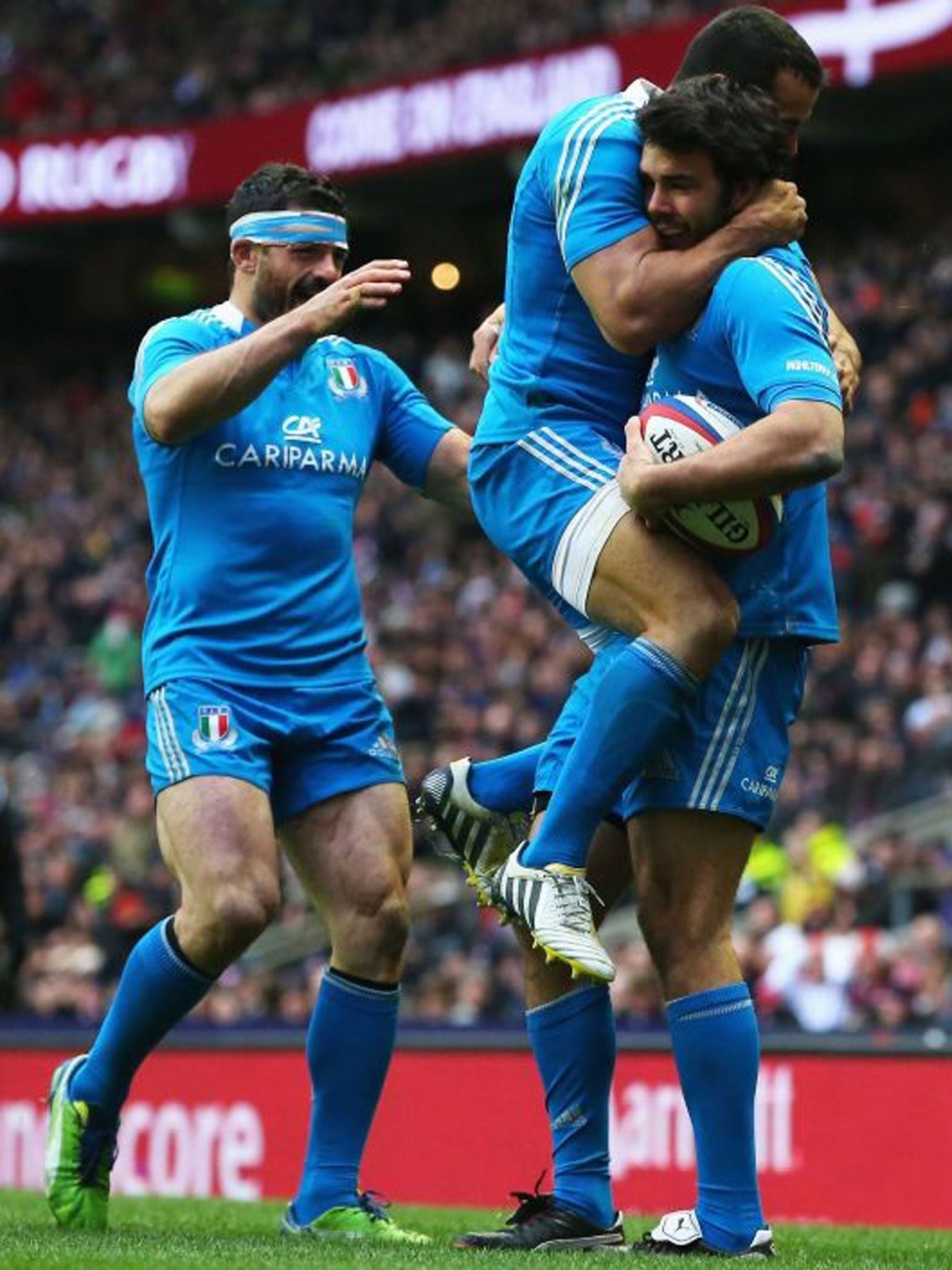 Tom McLean (far right) celebrates his try with Italy team-mates