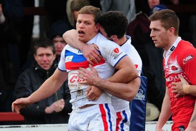 Wakefield's Peter Fox (left) is congratulated after scoring a try 