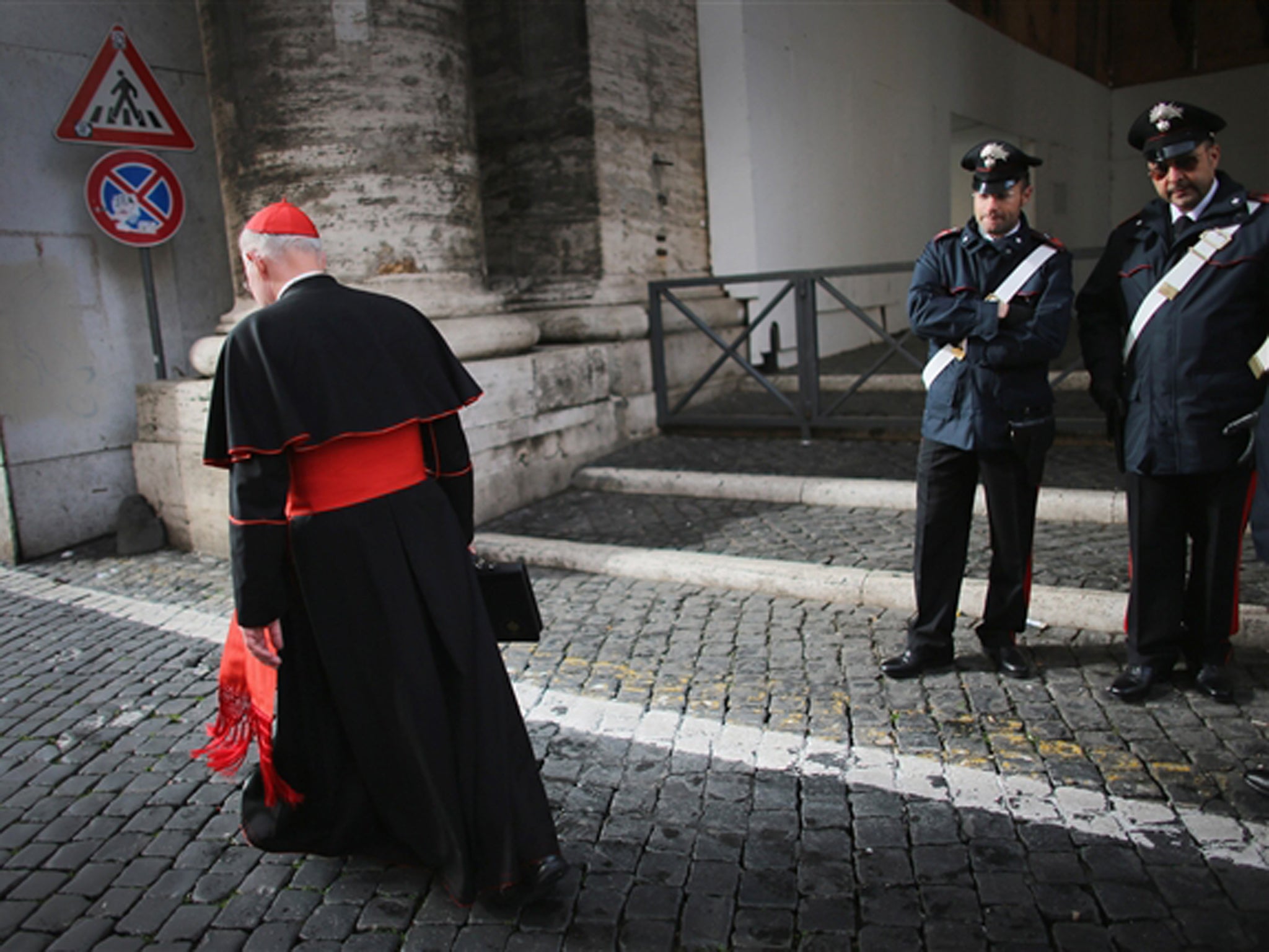A cardinal makes his way to Vatican City
