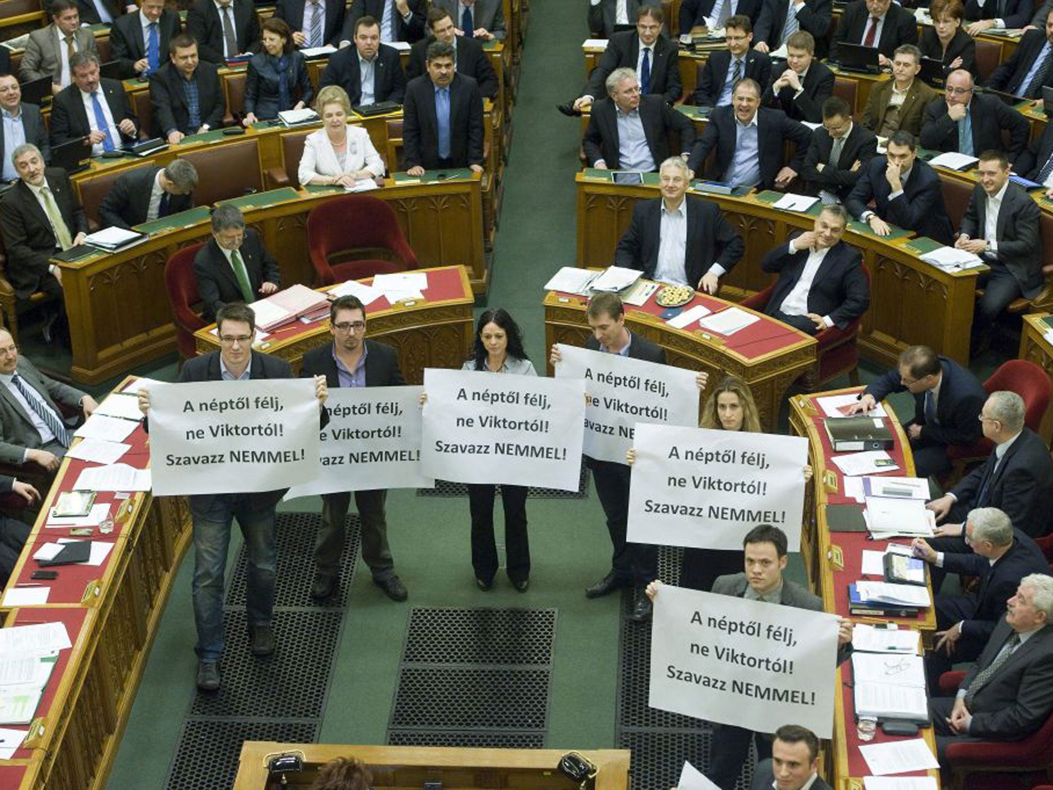 Members of the Parbeszed Magyarorszagert (Dialogue for Hungary) opposition party hold banners written: 'Fear the people, but do not fear Viktor! Vote NO!' prior to the voting of the modified Fourth Amendment of the Basic Law in the Parliament building in