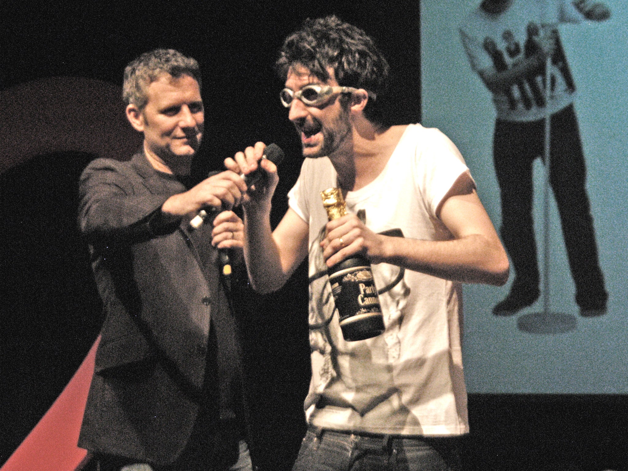 Thursday 11pm: It begins. Adam Hills helps out on the first of many silly challenges