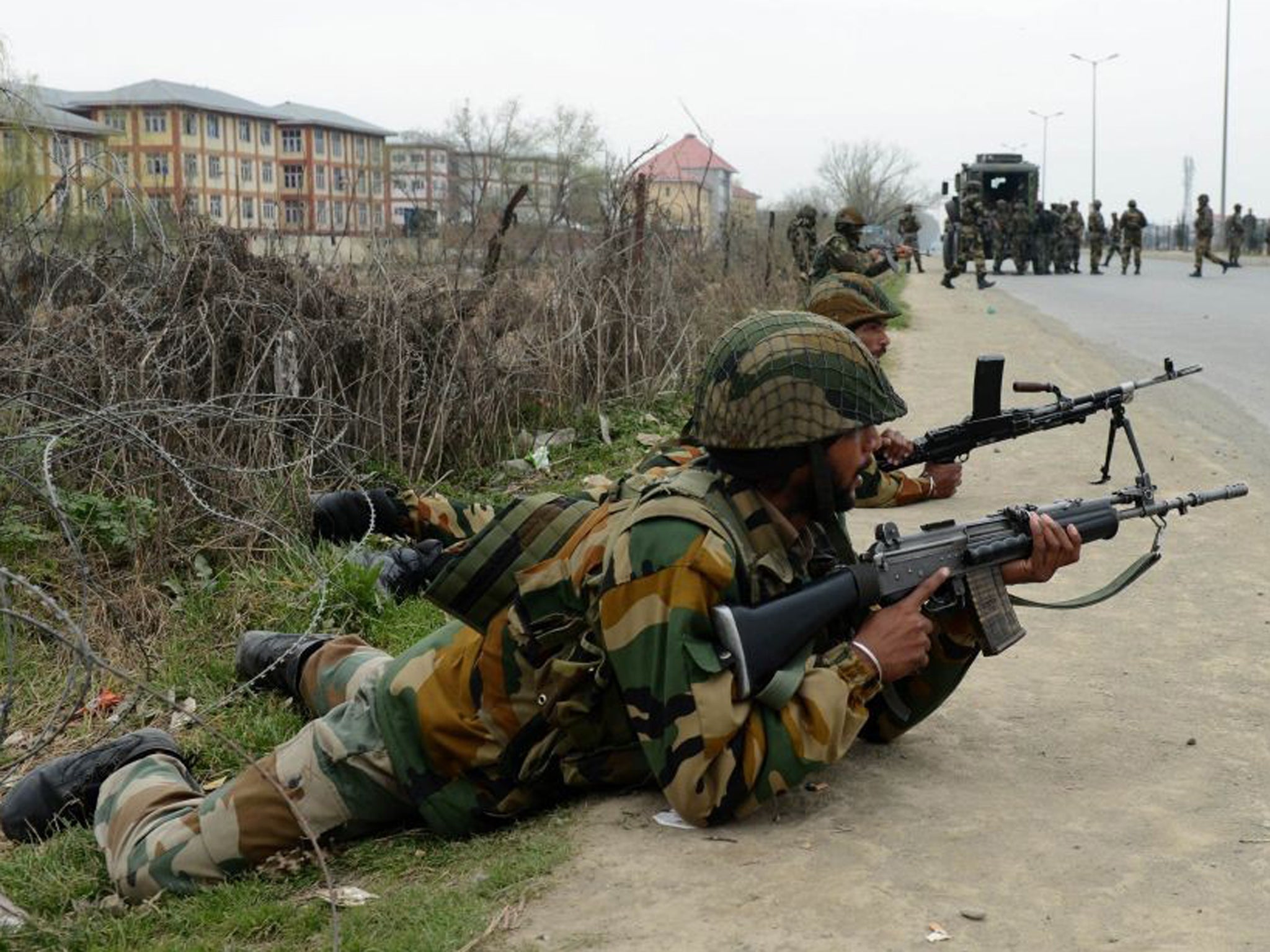 Indian soldiers take positions outside the school