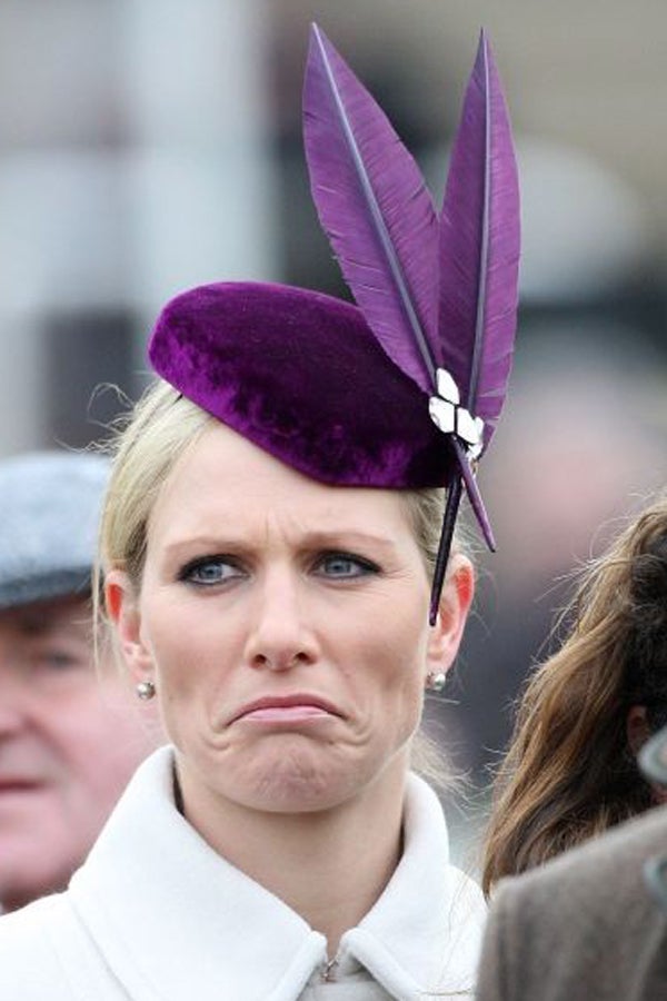 Zara Phillips looks as if her horse has not run well as she watches the Stan James Champion Hurdle at the Cheltenham Festival. She also looked bemused when she and her husband Mike Tindall were stopped by a security guard from accessing the parade ring