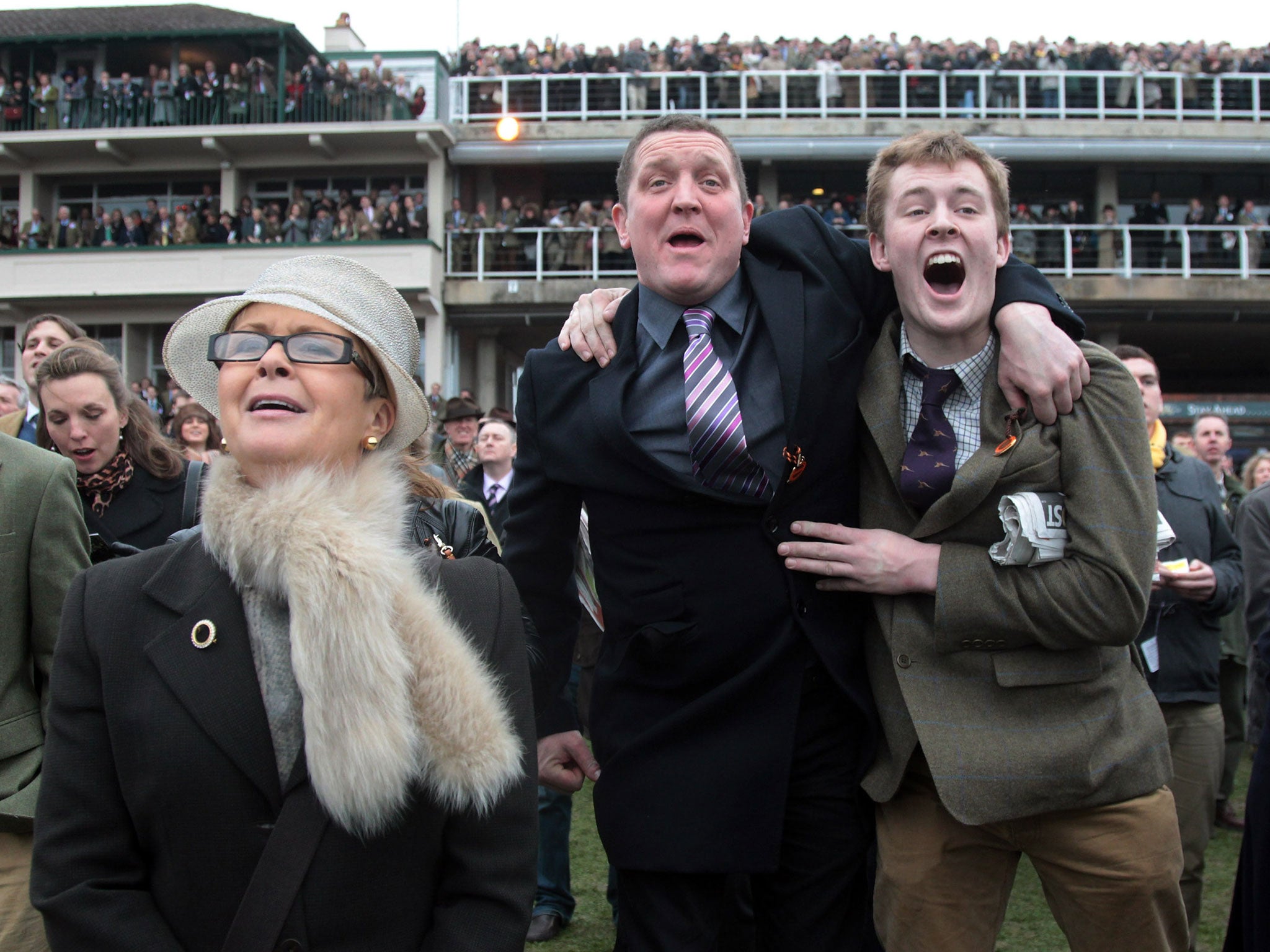 Racegoers cheers as they watch a race at the Cheltenham Festival 2012 on March 16, 2012 in Cheltenham, England.