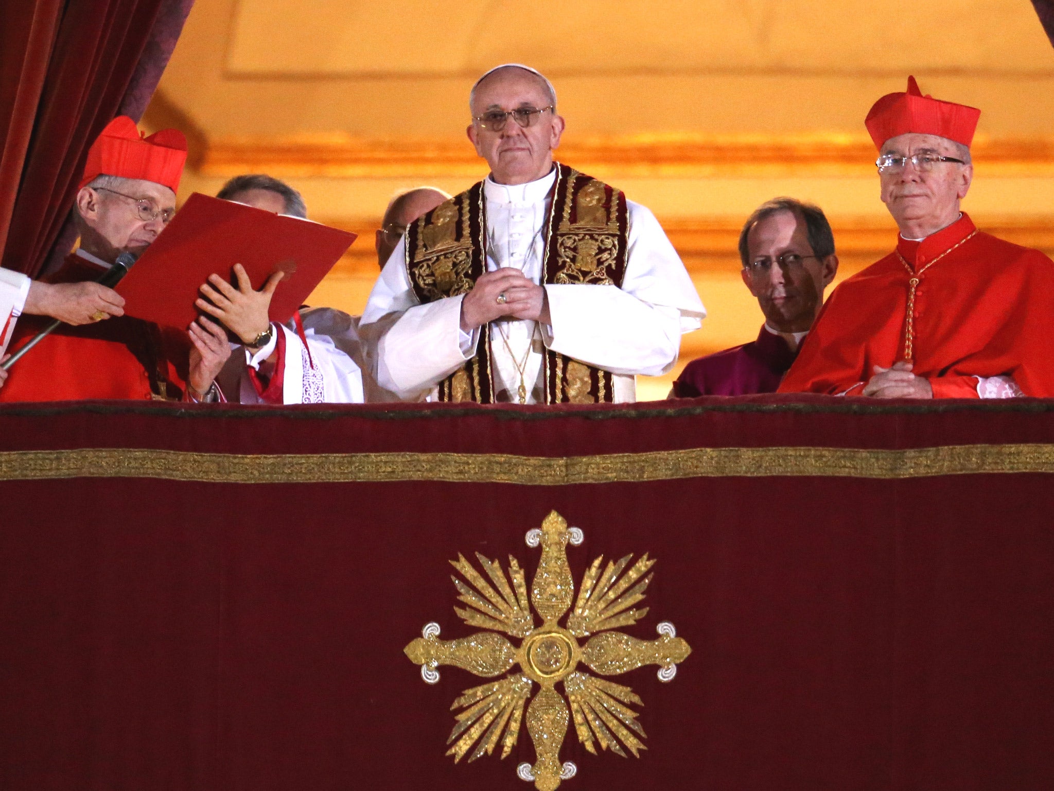 Newly elected Pope Francis I appears on the central balcony of St Peter's Basilica