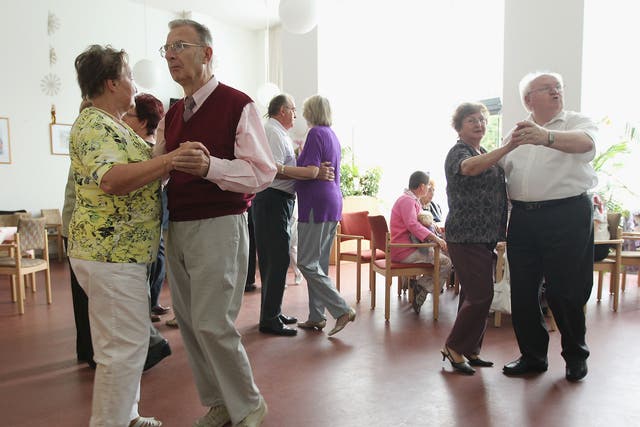 Elderly people dance during an afternoon get-together in the community room of the Sewanstrasse senior care home in Lichtenberg district on August 30, 2011 in Berlin, Germany.