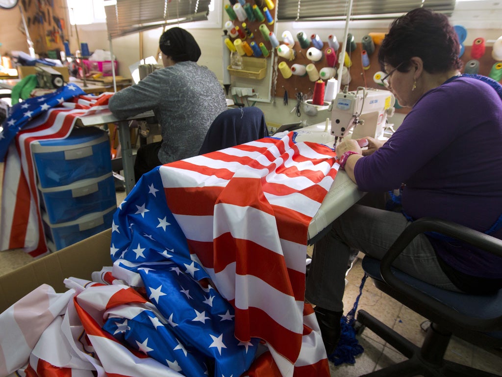 Israeli employees sew US flags at a workshop on March 11, 2013 in the town of Kfar Saba in preparation for the upcoming visit of US President Barack Obama. Obama's three-day visit to Israel and the Palestinian territories will begin on March 20, Israel sa