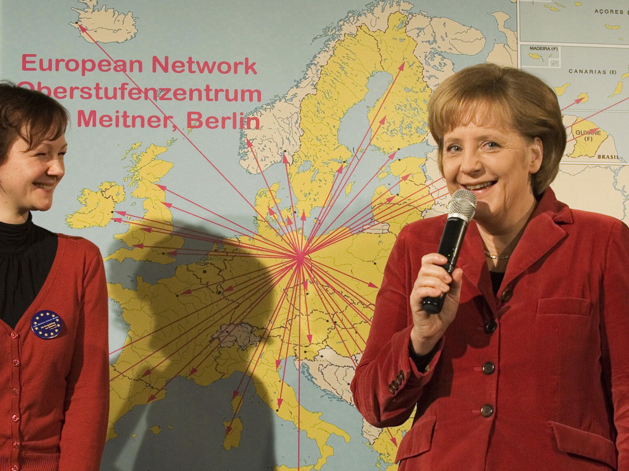 German Chancellor Angela Merkel (R) and Anja Schabanowski, former student of Berlin's Lise-Meitner-School, stand in front of a map of Europe on March 9, 2009 in Berlin.
