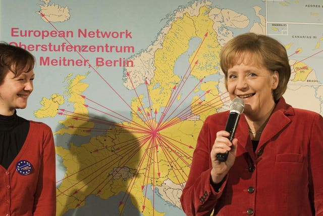 German Chancellor Angela Merkel (R) and Anja Schabanowski, former student of Berlin's Lise-Meitner-School, stand in front of a map of Europe on March 9, 2009 in Berlin.