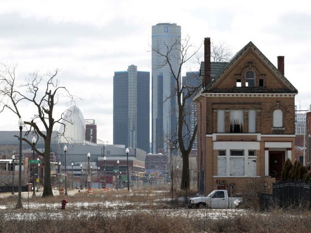 An empty house in Detroit in front of GM’s headquarters