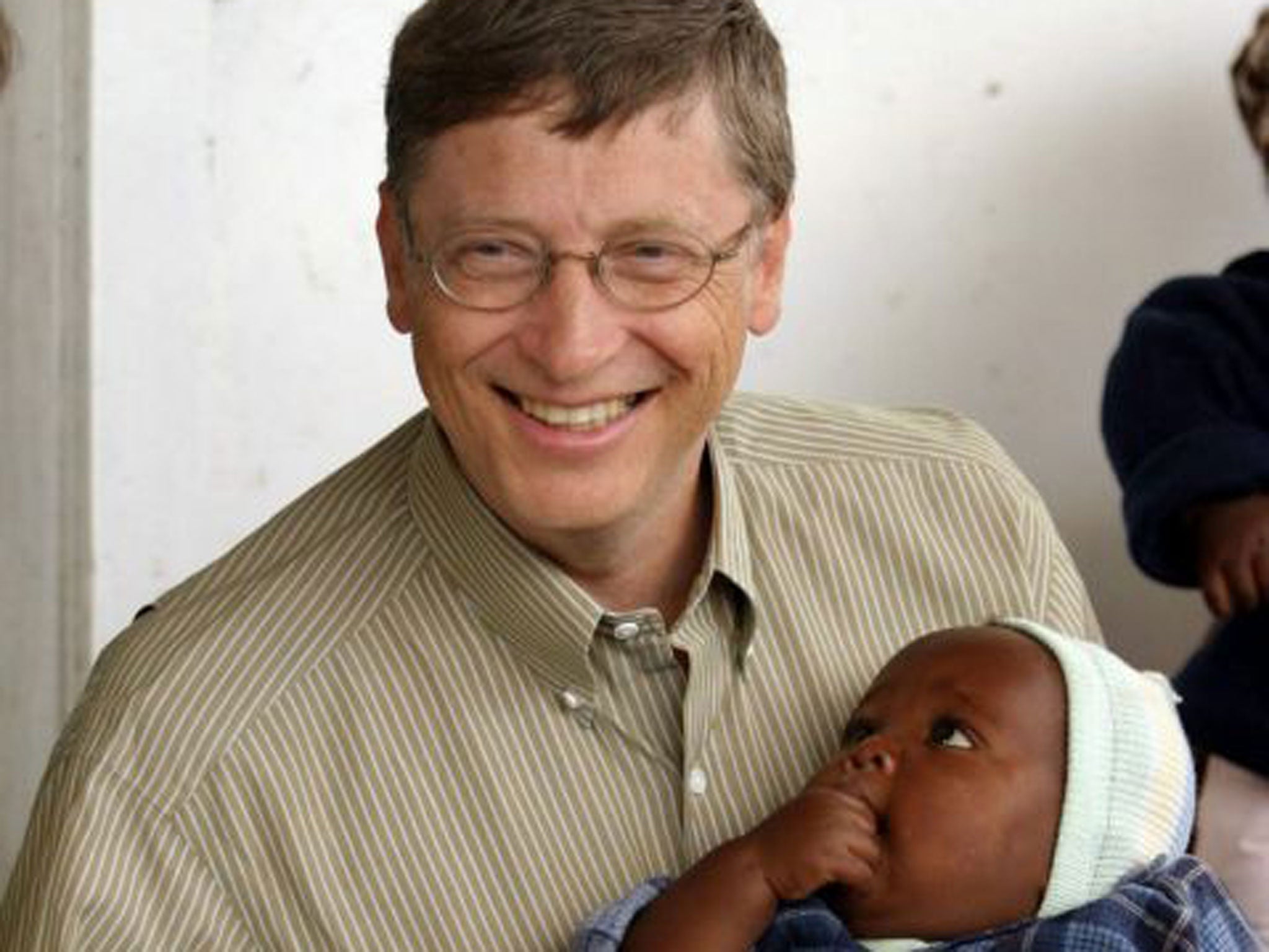 Bill Gates, co-founder of the Bill and Melinda Gates Foundation, with a young patient on a  malaria vaccine trial in Mozambique