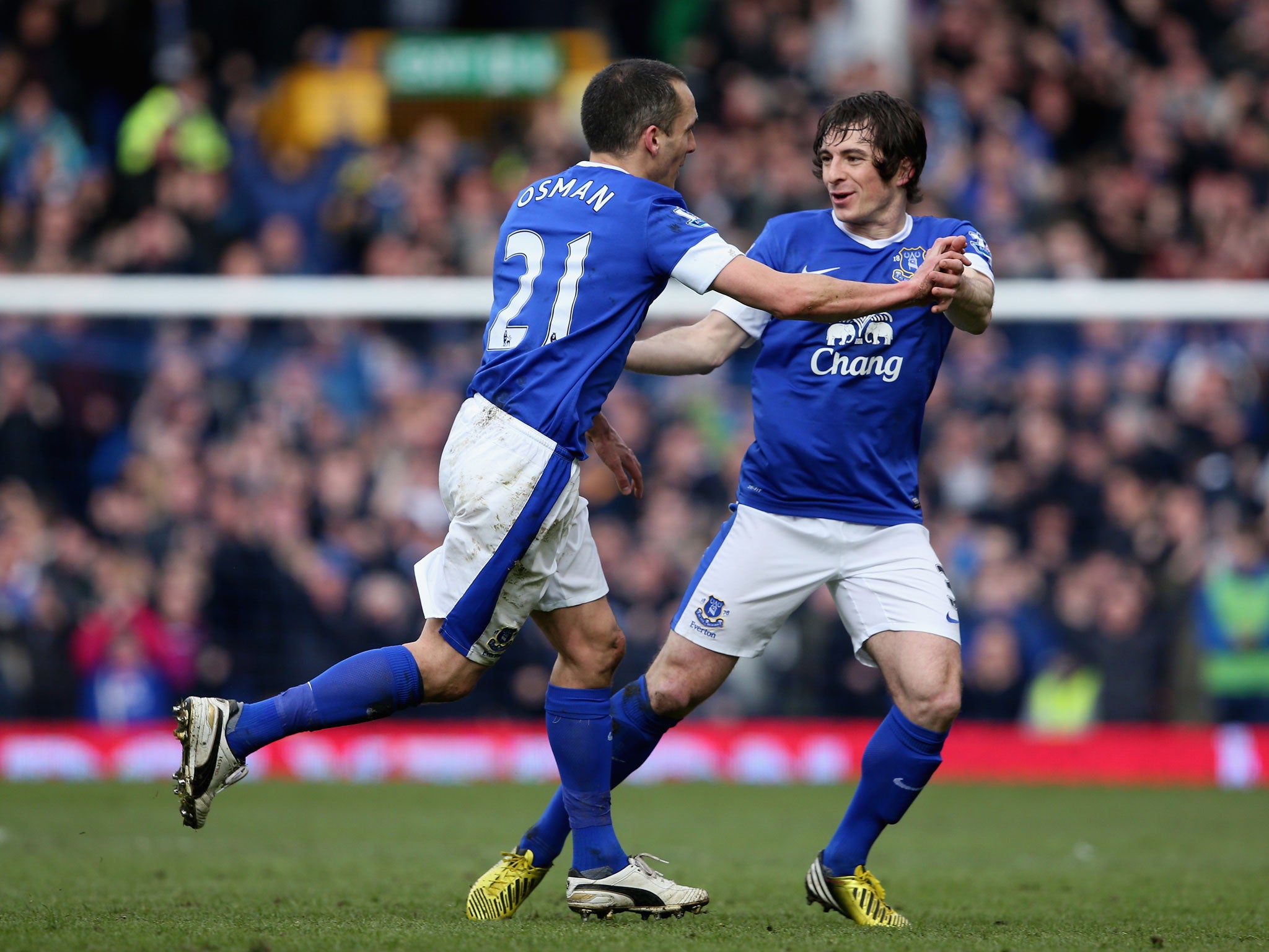 Leon Osman (l) of Everton celebrates scoring the opening goal with team-mate Leighton Baines