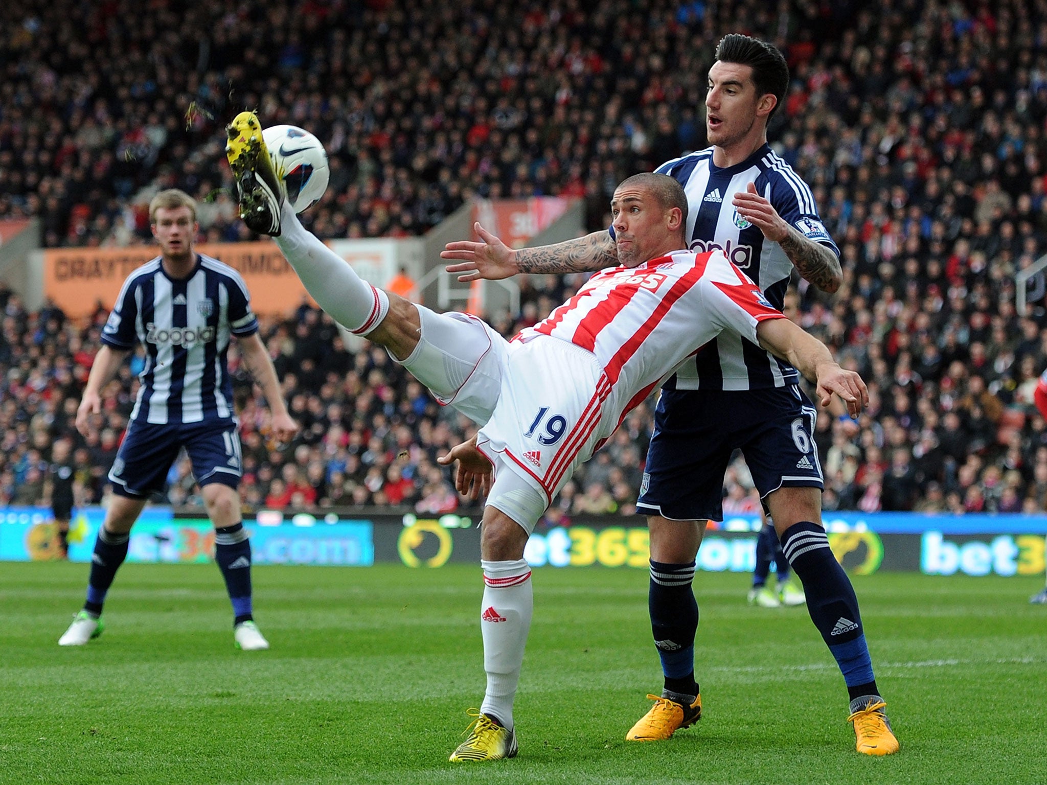 Jonathan Walters of Stoke City in action with Liam Ridgewell of West Bromwich Albion