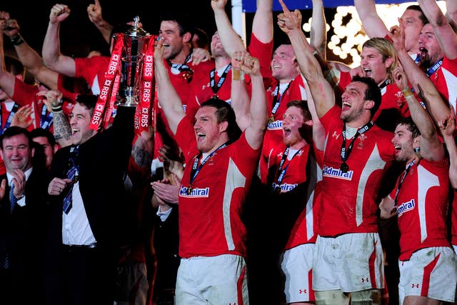 The injured Ryan Jones and Gethin Jenkins of Wales lift the Six Nations Championship trophy
