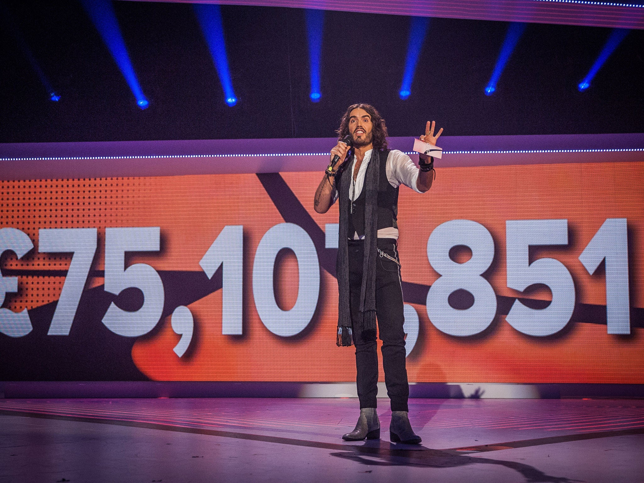 In the money: Russell Brand shows off a record-breaking tally