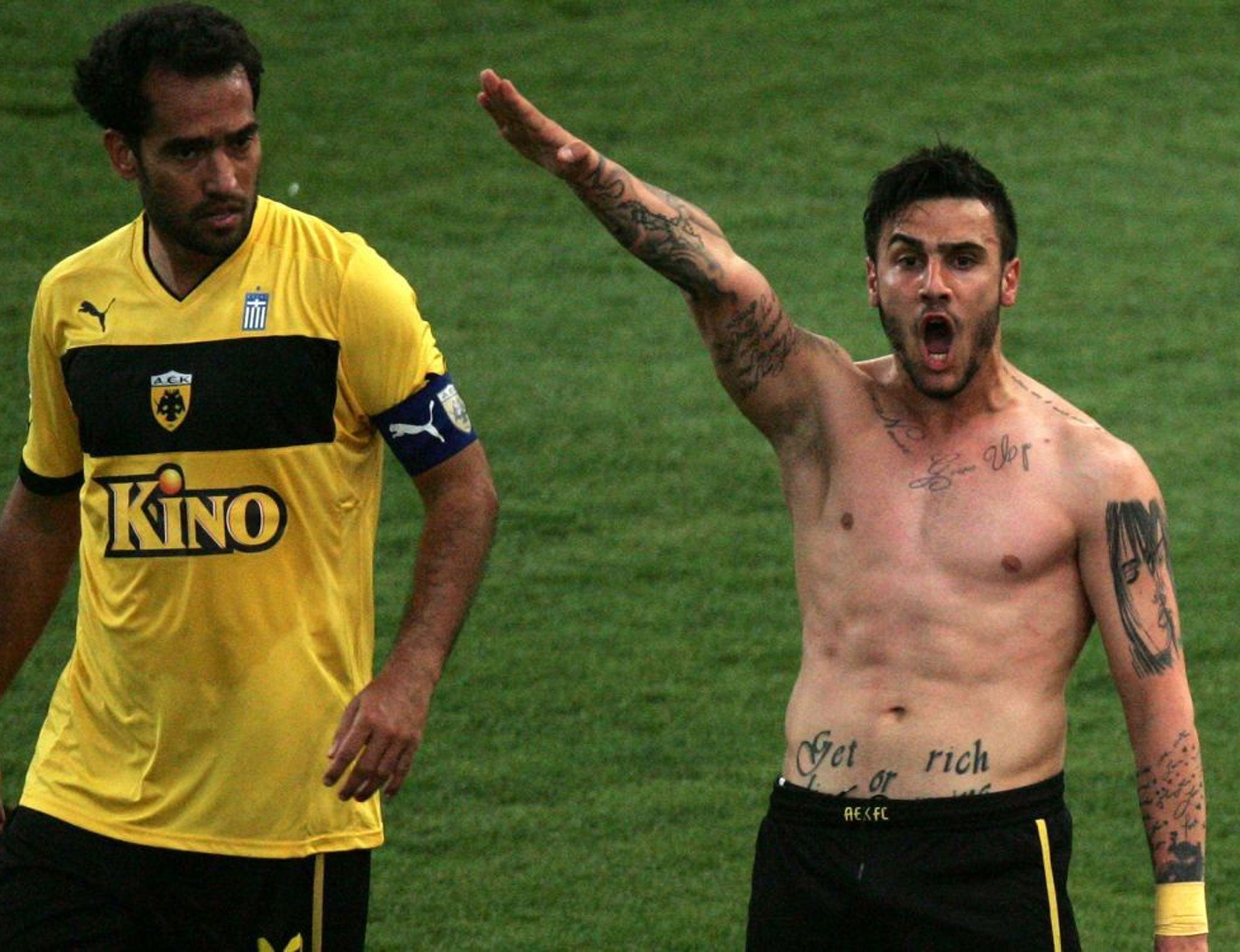 Giorgos Katidis gives what appears to be a fascist salute after scoring his side's winning goal against Veria, as his Brazilian team mate Roger Guerreiro looks on