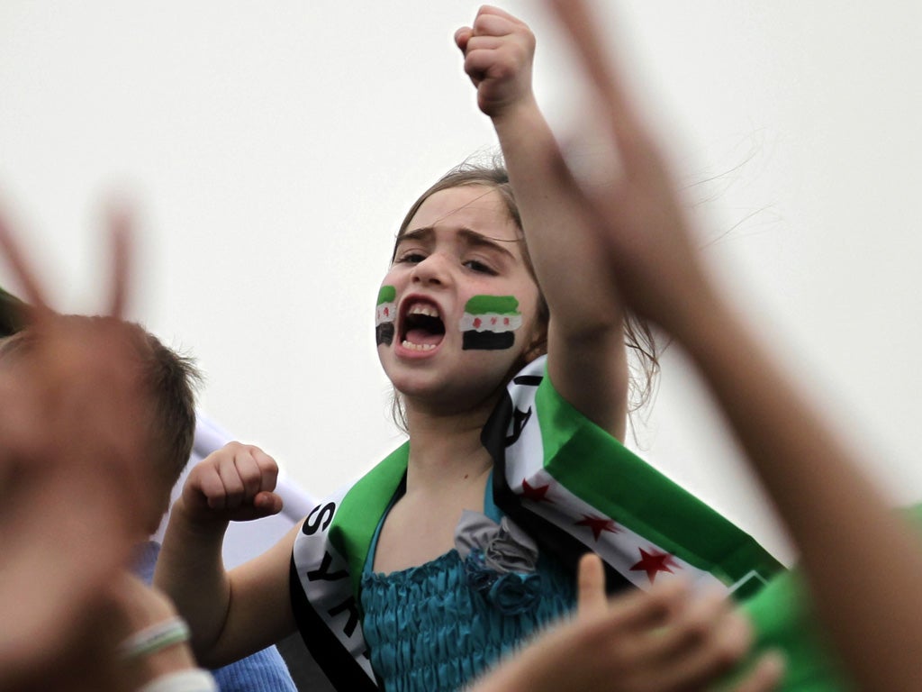 A Syrian girl living in Jordan shouts slogans during a demonstration against Syria's President Bashar al-Assad in front of the Syrian Embassy in Amman on March 15, 2013, marking the second anniversary of the Syrian conflict.