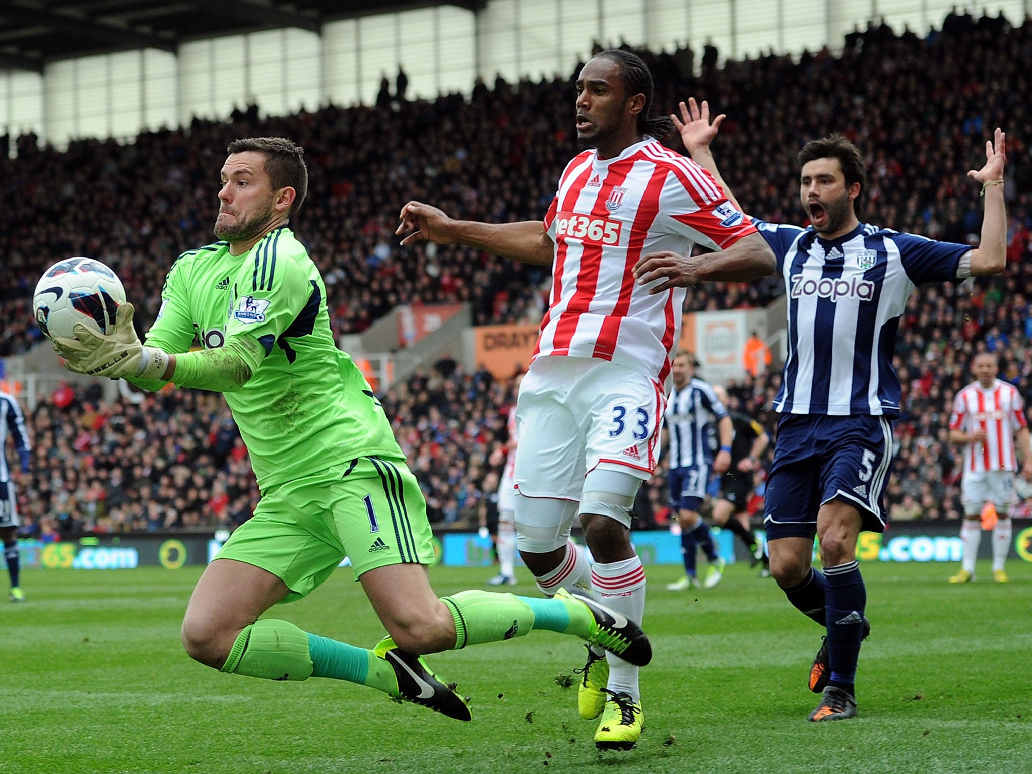 Ben Foster grabs the ball as Stoke’s Cameron Jerome closes in