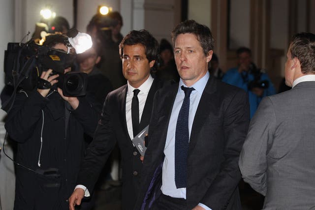 Actor Hugh Grant leaves after giving evidence to the Leveson Inquiry at The Royal Courts of Justice on November 21, 2011 in London, England.