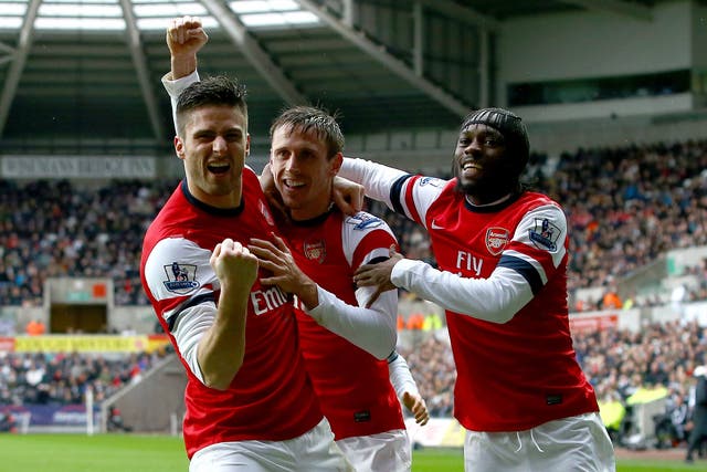 Nacho Monreal of Arsenal (C) celebrates his goal against Swansea with team mates Olivier Giroud(L) and Gervinho 