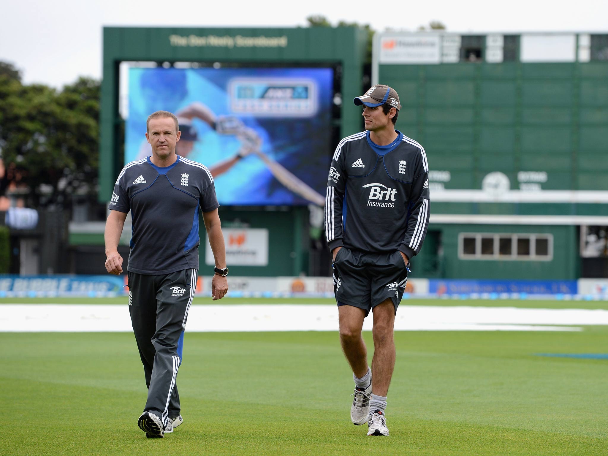 England captain Alastair Cook and coach Andy Flower walk on to the outfield to inspect the ground before rain cause the Test with New Zealand to end in a draw