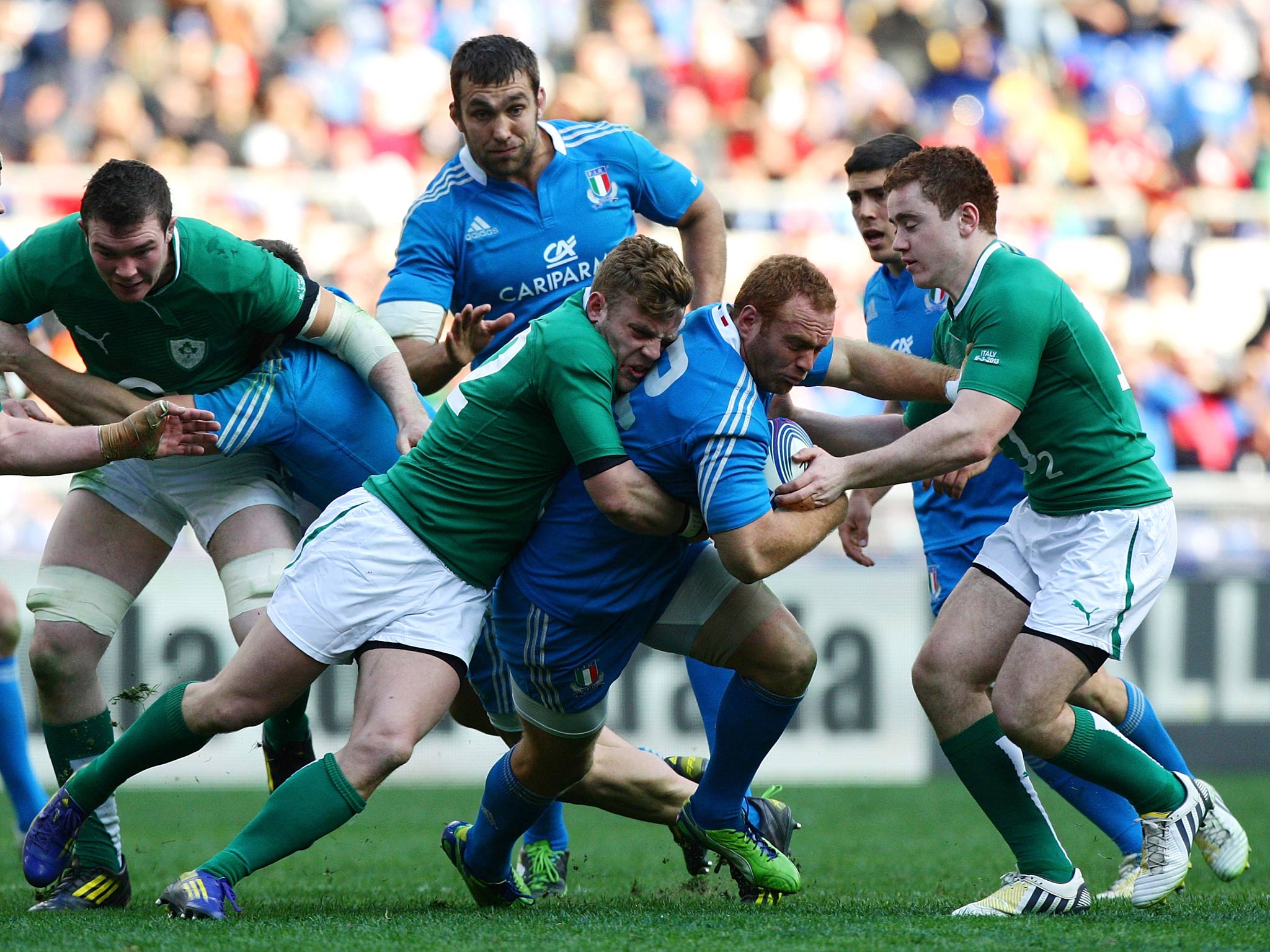 Gonzalo Garcia of Italy (C) is tackled during the RBS Six Nations match between Italy and Ireland